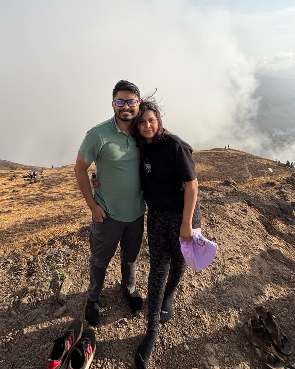 Sahil and his wife at the summit of Salher Fort, above the cloud line